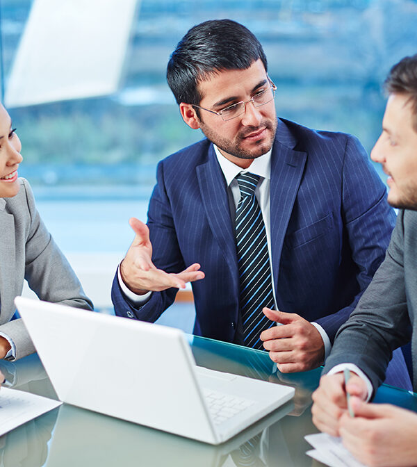 Happy businesspeople explaining colleague the main points of new project